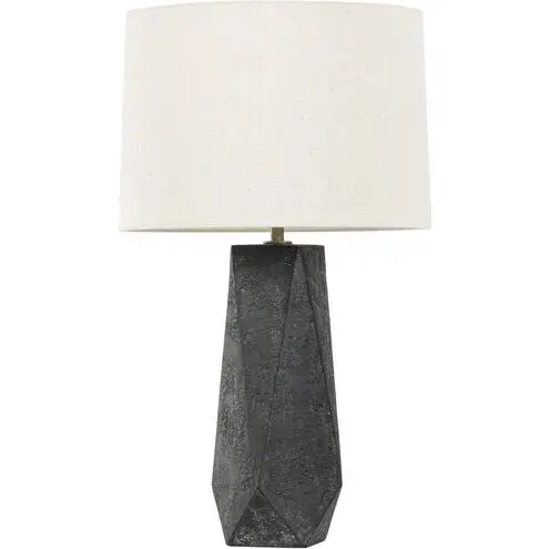 The Coronado table lamp brings modern sculptural presence with its hand-hewn geometric ceramic base. The chalky black ceramic paired with natural linen shade creates sophisticated contrast, while patina brass accents add warmth.