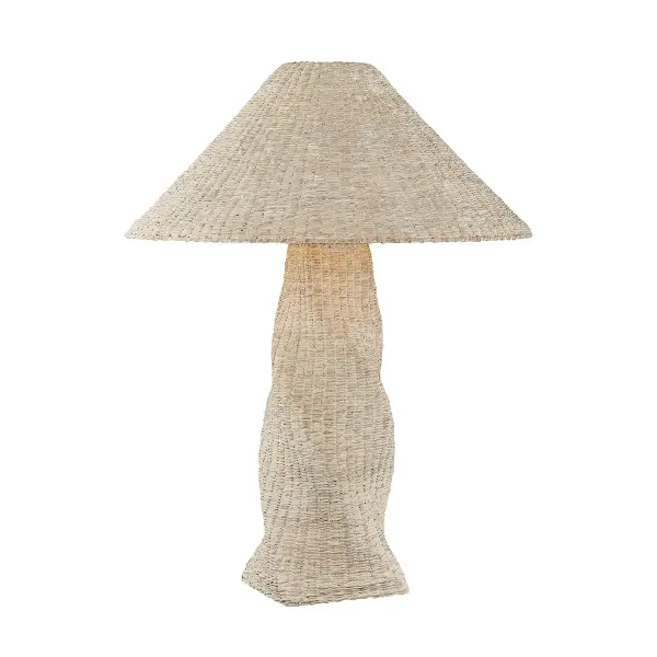 The Zaire table lamp showcases exceptional craftsmanship with hand-woven whitewashed seagrass creating a sculptural, organic form. The twisted tapering base and matching shade deliver visual interest, while Patina Brass accents add warmth.