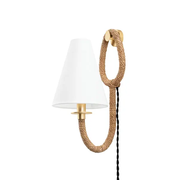 The Deaver sconce brings coastal charm with its abaca rope-wrapped arm and vintage gold finish. As a plug-in fixture, it offers flexible placement without hardwiring. The natural materials and earthy palette create a relaxed, organic aesthetic.