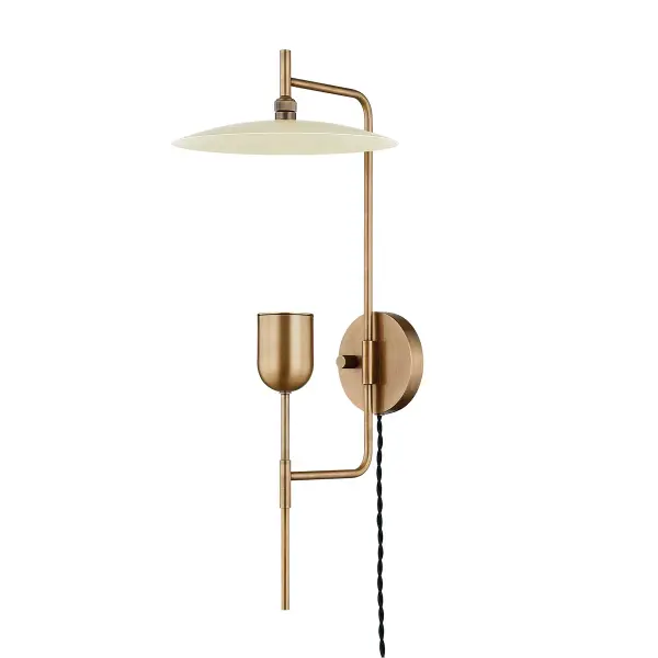 The Manti wall sconce combines geometric precision with functional flexibility. Its pivoting shade and upward-reflecting brass cup create ambient lighting with industrial sophistication, perfect for task or accent lighting.
