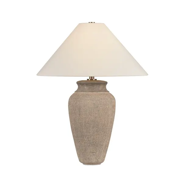 The Vessel table lamp by designer Lauren Liess brings museum-quality artistry to residential spaces. Its elongated ceramic base features richly textured, hand-layered finish reminiscent of ancient pottery, paired with a crisp white linen shade and subtle brass accents.