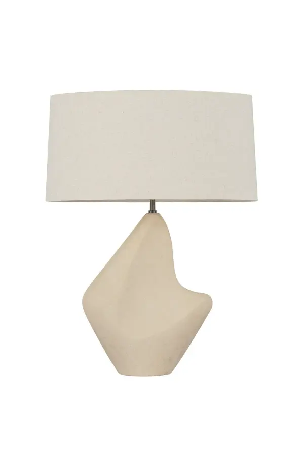 The Huntly table lamp transforms ancient stone relic aesthetics into refined modern form. Its matte ceramic base features distinctive concave cut-outs that evoke water-worn surfaces, creating dramatic shadow play and visual interest.