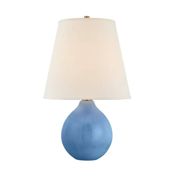 The Jarvis table lamp features a distinctive hand-shaped ceramic base with Dappled Lapis glaze that creates unique color variations in each piece. The oversized linen shade balances the sculptural base beautifully.