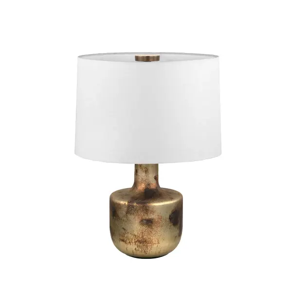 The Terron table lamp blends Indian craftsmanship with Japanese pottery aesthetics, featuring a handmade glass base with lustrous patina brass finish and tonal variations. Each piece is unique with natural color variations.