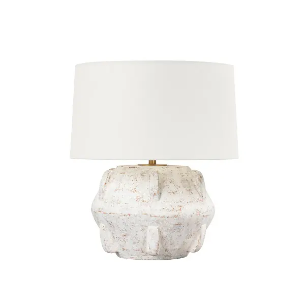 The Vanda table lamp brings organic warmth with its whitewashed ceramic base that evokes ancient pottery. The wide linen drum shade diffuses light beautifully while the patina brass accents add refined sophistication to its earthy aesthetic.