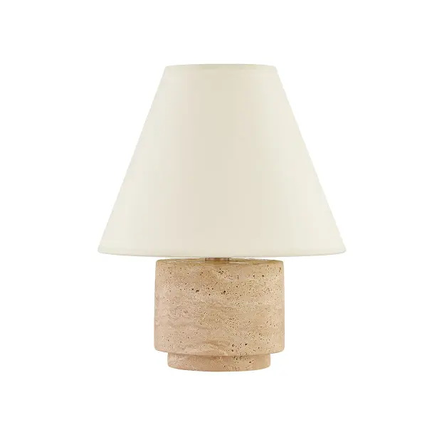 The Bronte table lamp combines natural travertine stone with handmade paper and patina brass accents for a sophisticated organic aesthetic. Each piece is unique due to natural stone variations. Compact 12-inch profile works well in multiple settings.