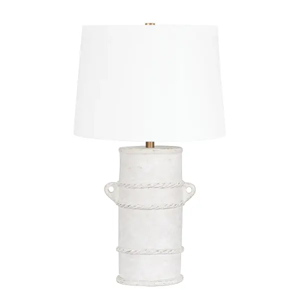 The Siena table lamp reimagines ancient pottery with contemporary flair. Its hand-sculpted terracotta base features rope-like details and distinctive handles, finished in weathered whitewash that adds organic texture to any space.