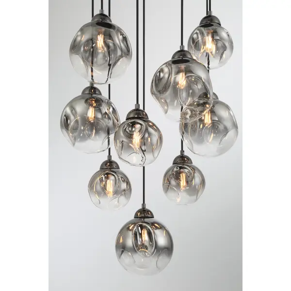 The Neveh 9-Light Pendant combines modern industrial design with sophisticated smoke grey glass shades. Its gun metal finish and generous 24-inch width create dramatic visual impact perfect for dining rooms and kitchen islands. - alternate view