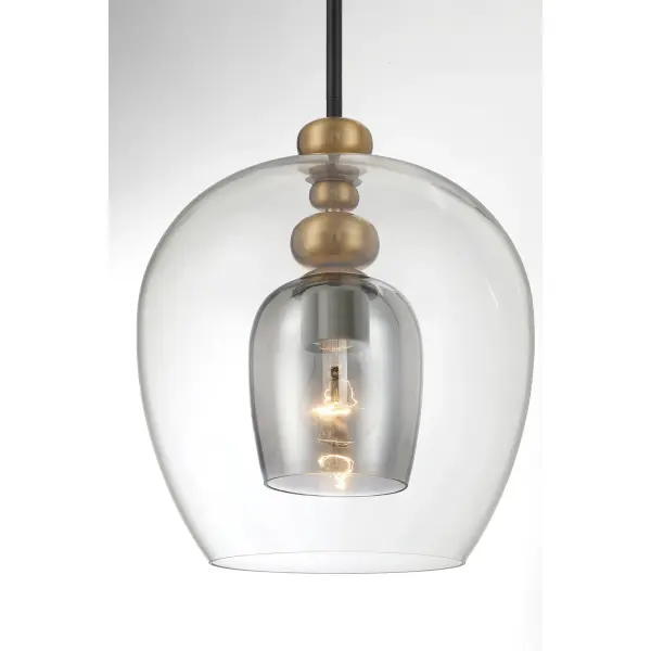 The Amesbury pendant combines coal black steel with oxidized aged brass accents and smoked gray glass for a refined industrial aesthetic. Its compact 11.75-inch width makes it perfect for intimate spaces or clustered installations. - alternate view