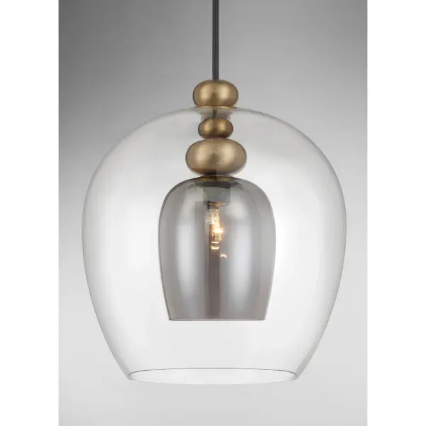 The Amesbury pendant blends traditional elegance with industrial edge through its distinctive coal and oxidized aged brass finish. The smoked gray glass shade adds depth while diffusing light beautifully for ambient dining or task lighting. - alternate view