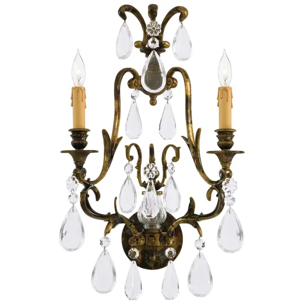This exquisite wall sconce combines Old World craftsmanship with transitional design. Handcrafted in Italy with solid cast construction and oxidized brass finish, it features authentic Bohemian crystals that add refined sparkle to any space.