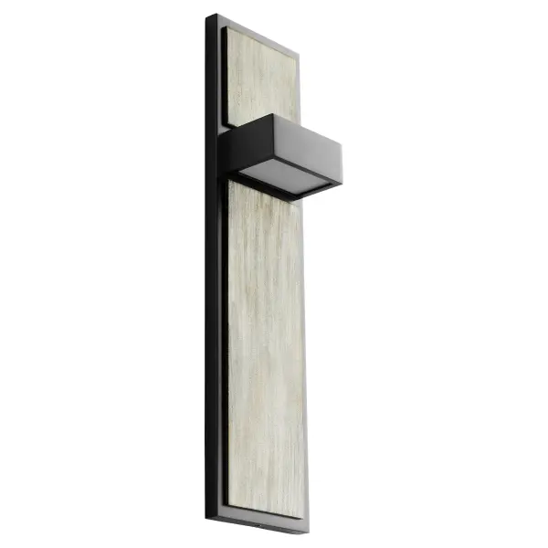 The Guapo Wall Sconce combines sleek black metal with weathered oak for a refined modern aesthetic. Its dual-directional lighting creates beautiful ambient glow while the natural wood finish adds warmth to contemporary spaces.
