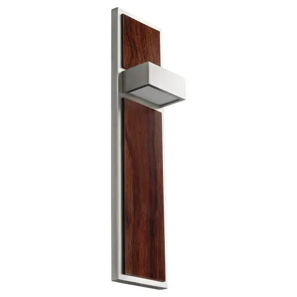 The Guapo Wall Sconce combines sophisticated minimalist design with the natural warmth of walnut wood. Its dual-directional lighting creates beautiful ambient glow while the satin nickel finish adds modern elegance.